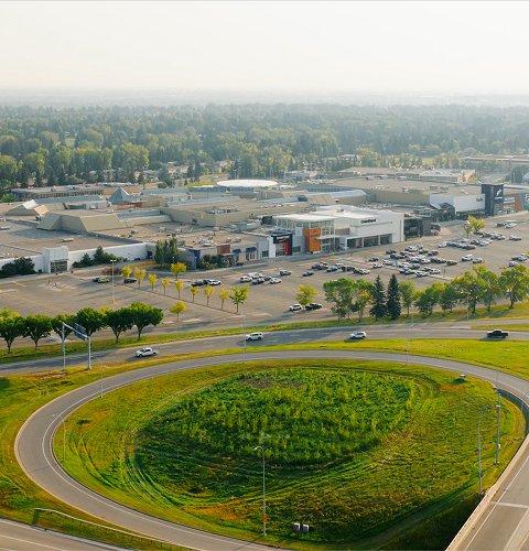Aerial view of a landscaped highway interchange with a green loop