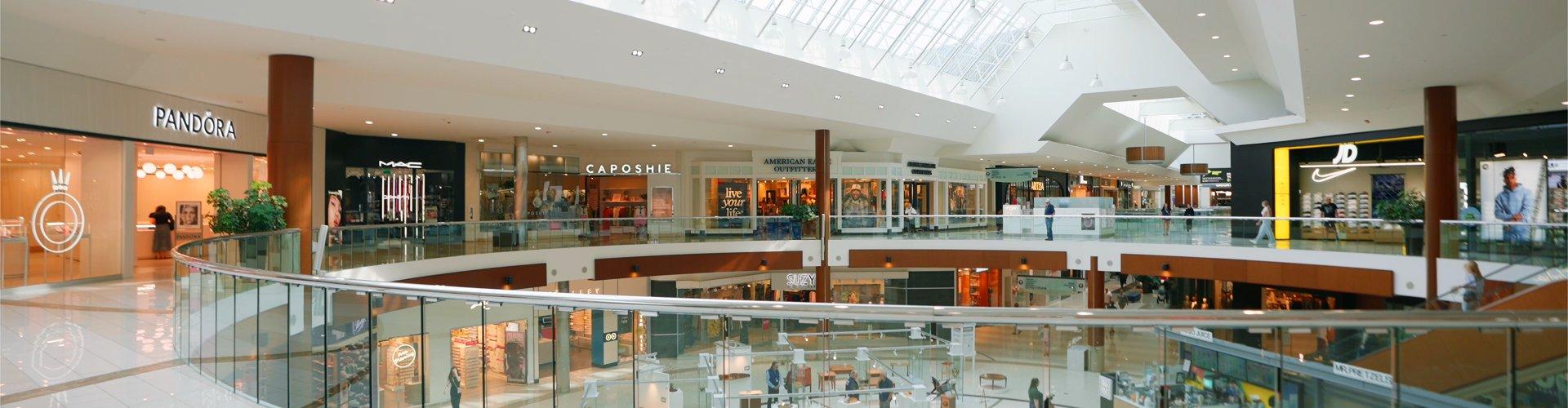 Two-level mall interior with Pandora, MAC and JD stores under a skylight