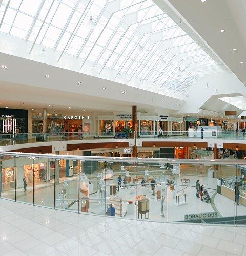 Two-level mall interior with Pandora, MAC and JD stores under a skylight
