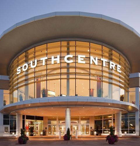 Illuminated curved Southcentre sign on the mall's glass facade at dusk