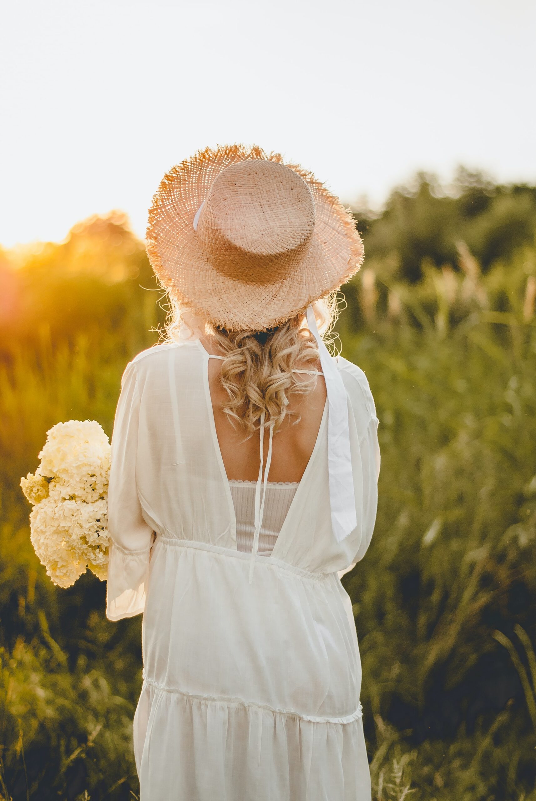 Girl in a white dress and straw hat
