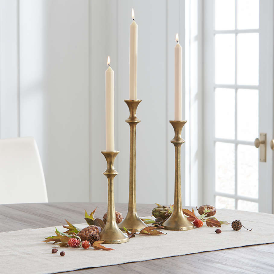 Three gold candle holders on an fall inspired table spread