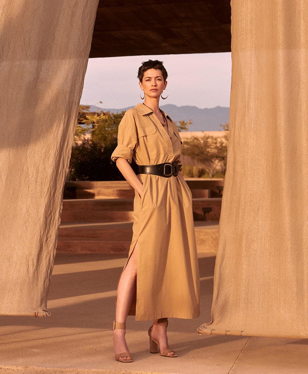 image of a woman in a desert setting wearing a khaki dress