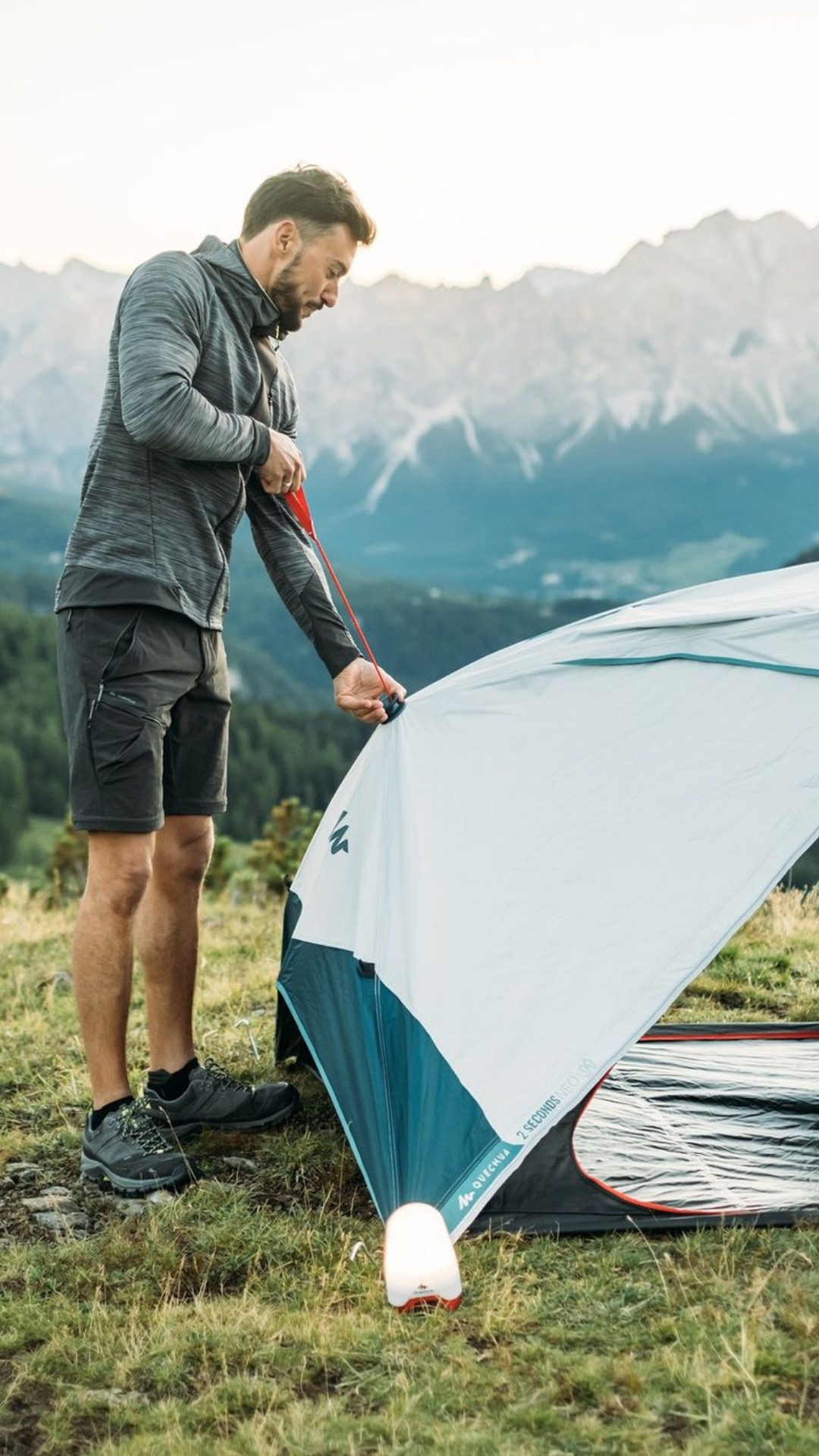 image of a man setting up a tent
