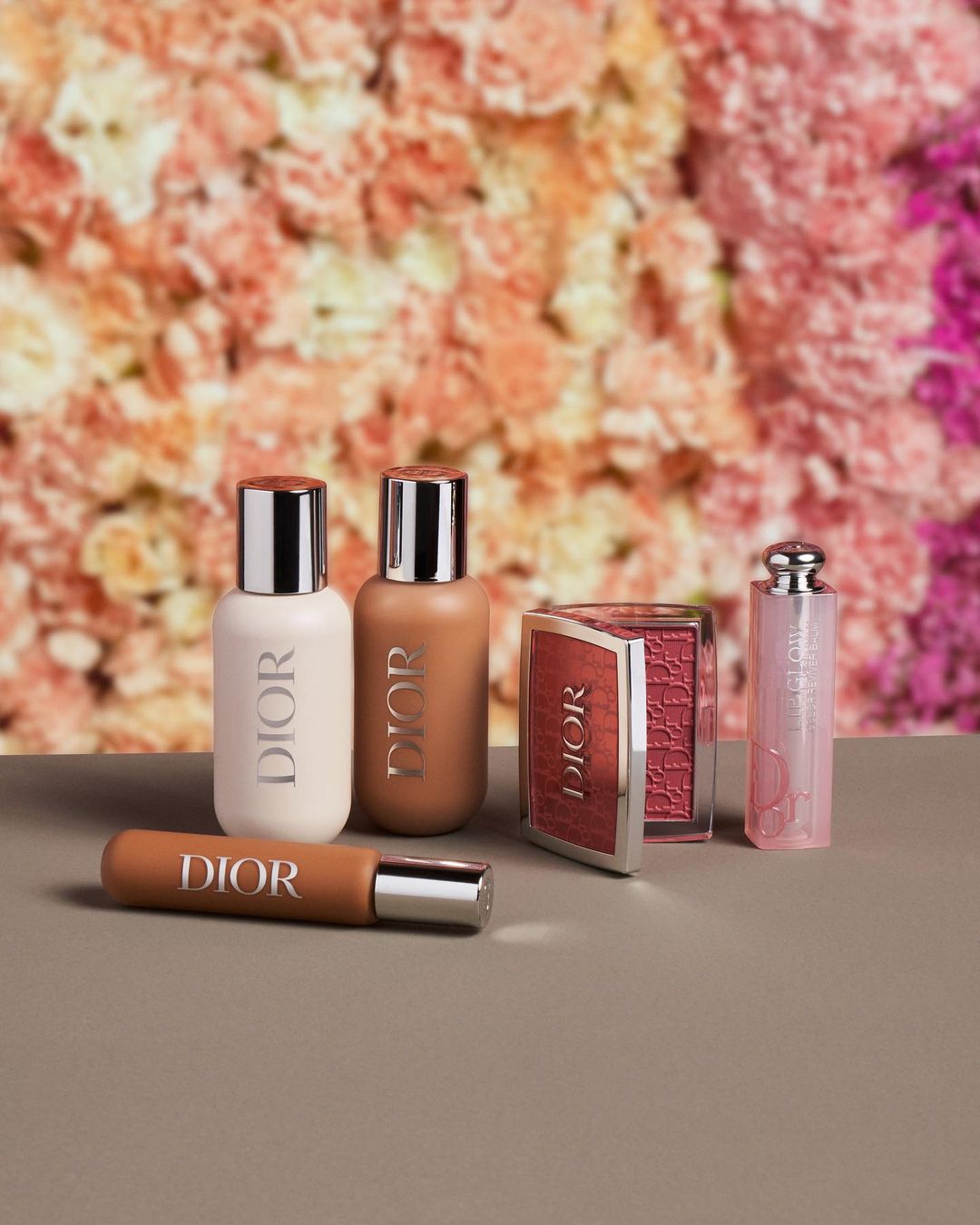 image of various Dior beauty products against a floral backdrop