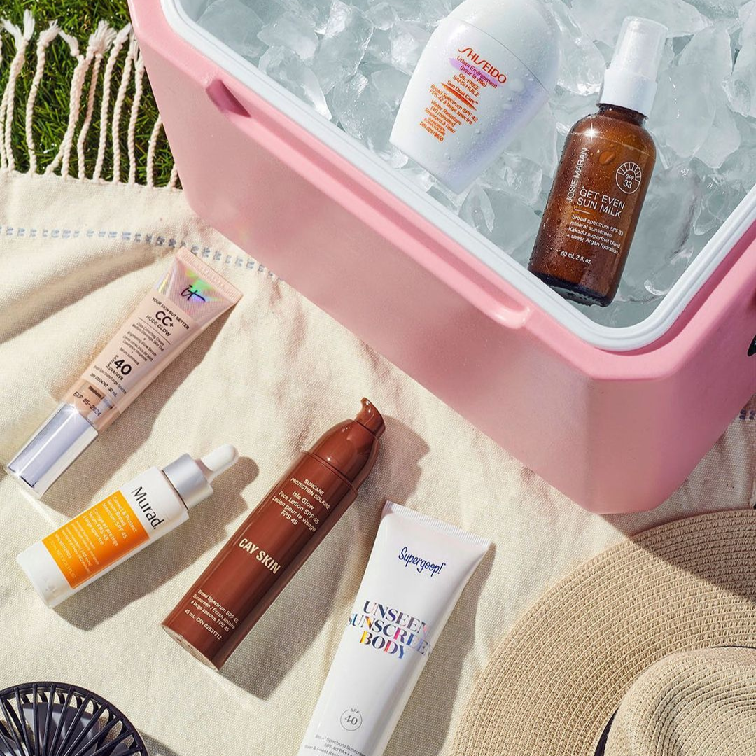 image of various beauty products from sephora. two are in a pink cooler over ice and four other products are laid out on a beach blanket