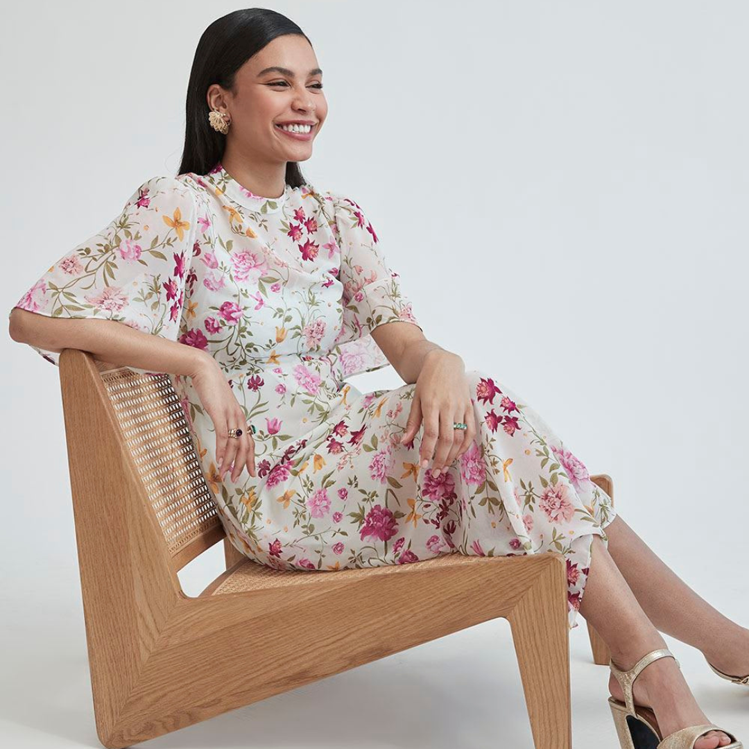 image of a woman sitting in a chair wearing a floral dress