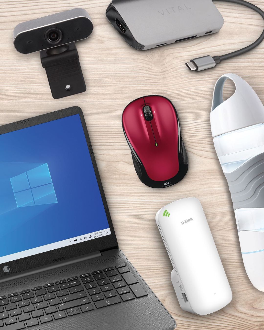 flat lay of various electronics including a laptop, webcam and mouse