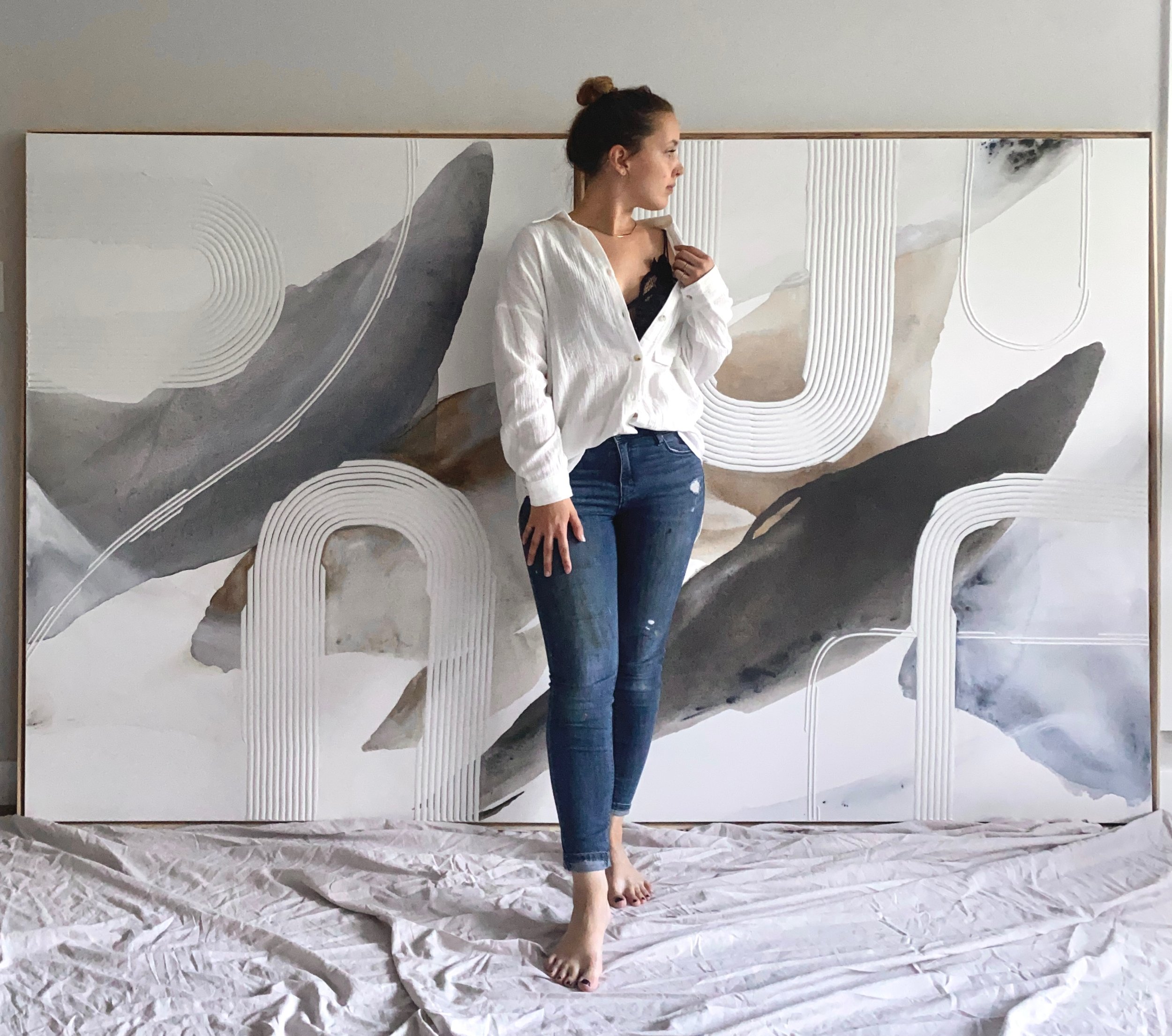 Morgan Cupido standing in front of a large painting.