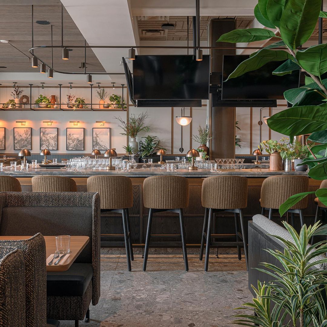 A room with a bar and chairs.