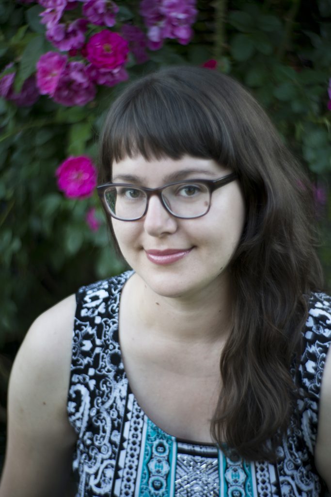 Helen Hajnoczky with glasses smiling.