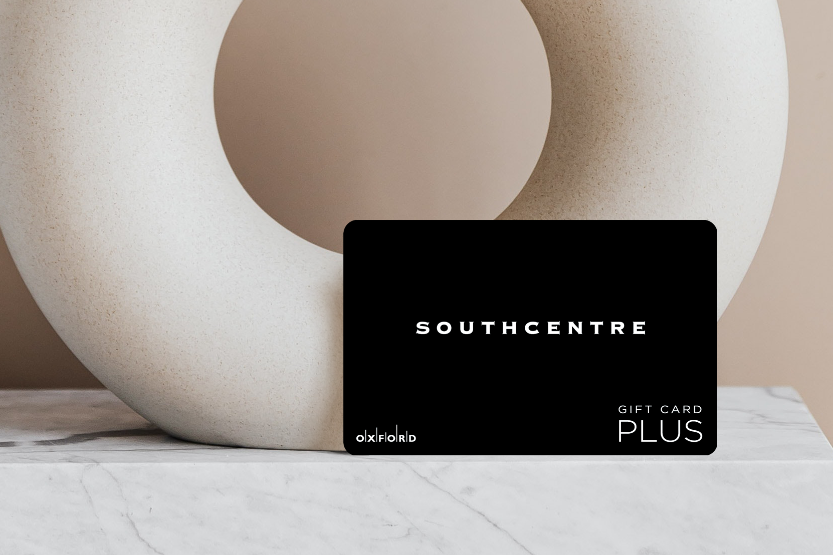promotional image of a black southcentre gift card in front of an oval ceramic vase