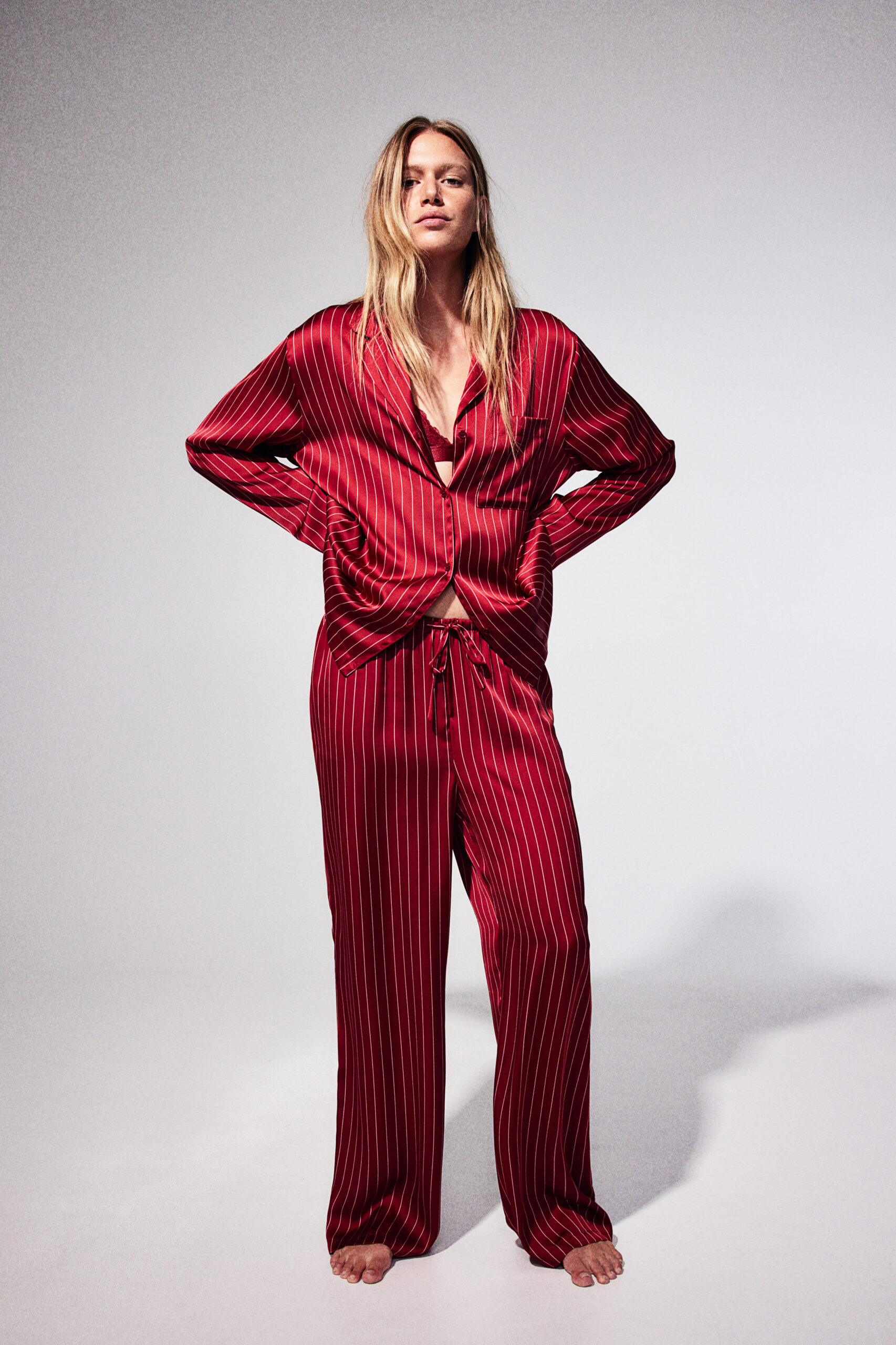 woman in red and white striped satin pajamas