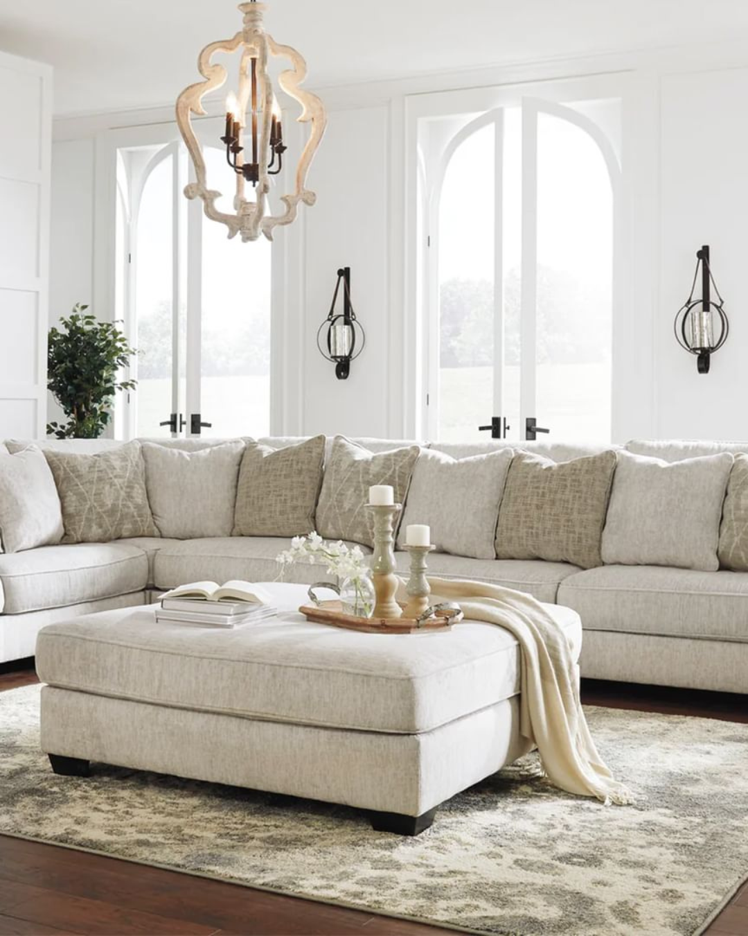 a living room with a large couch and a chandelier