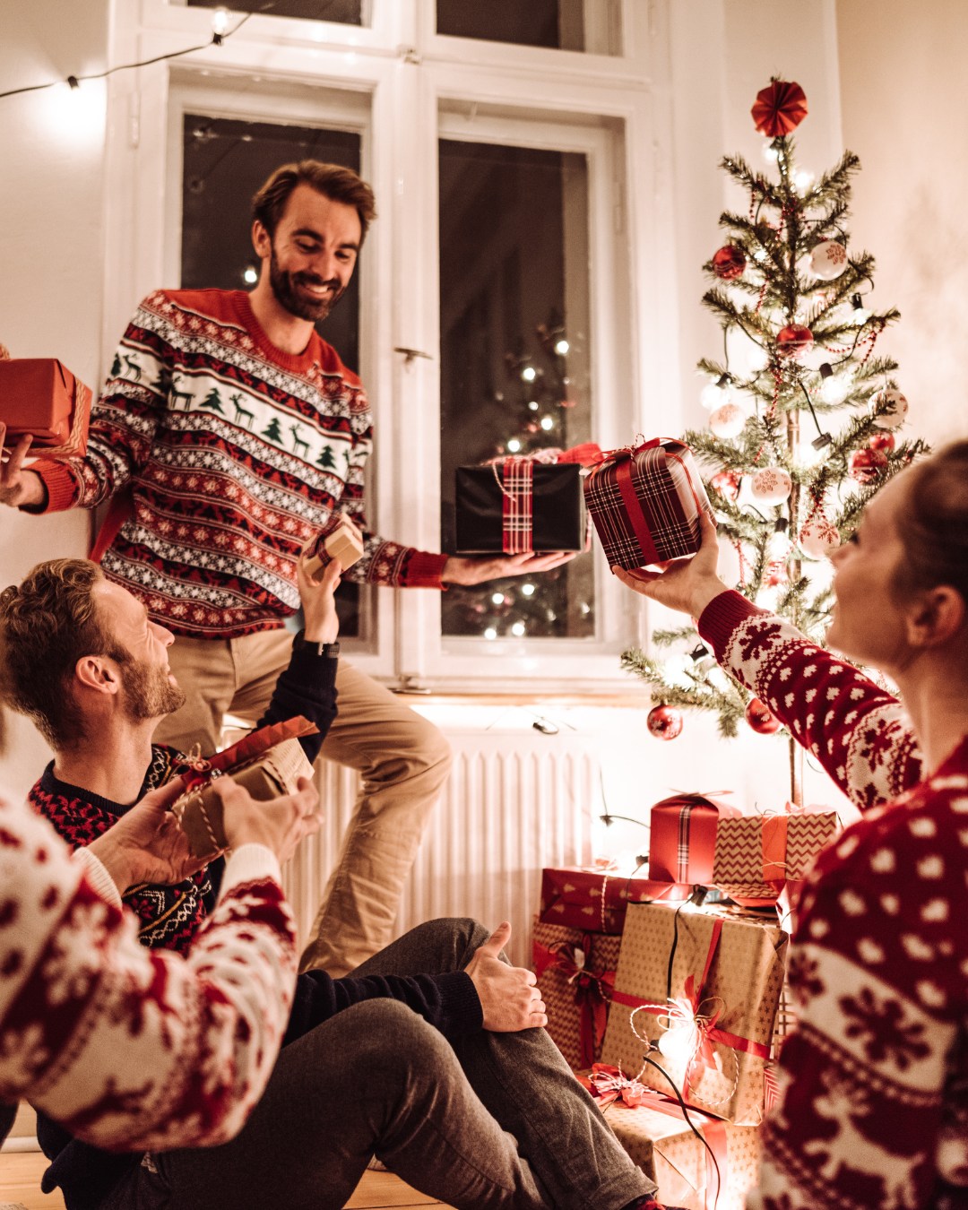 a group of people in sweaters holding presents