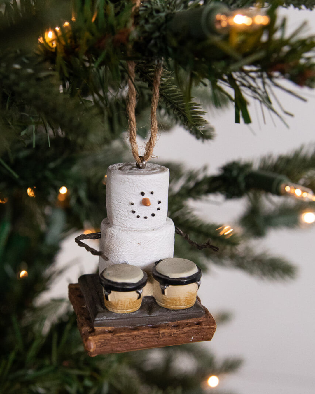 a snowperson and drums ornament from a tree
