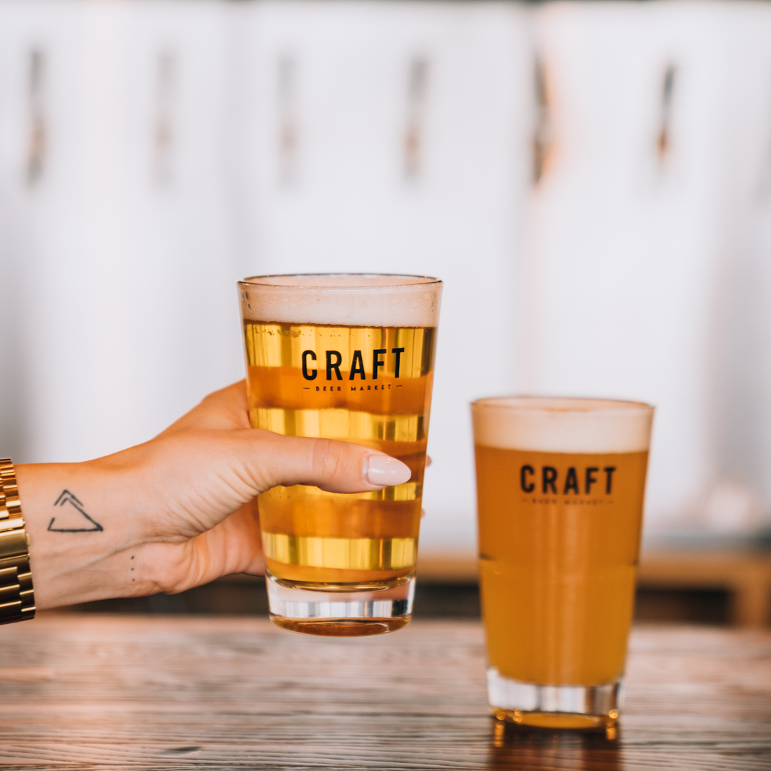 person holding craft beer glass