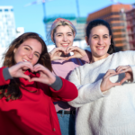 a group of women making a heart with their hands
