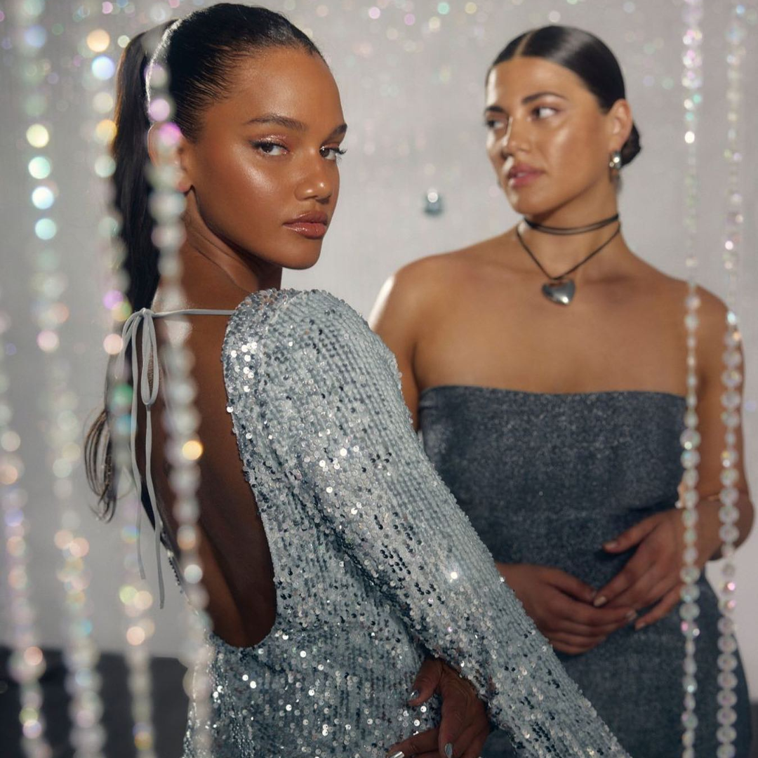 two women in sparkly dresses