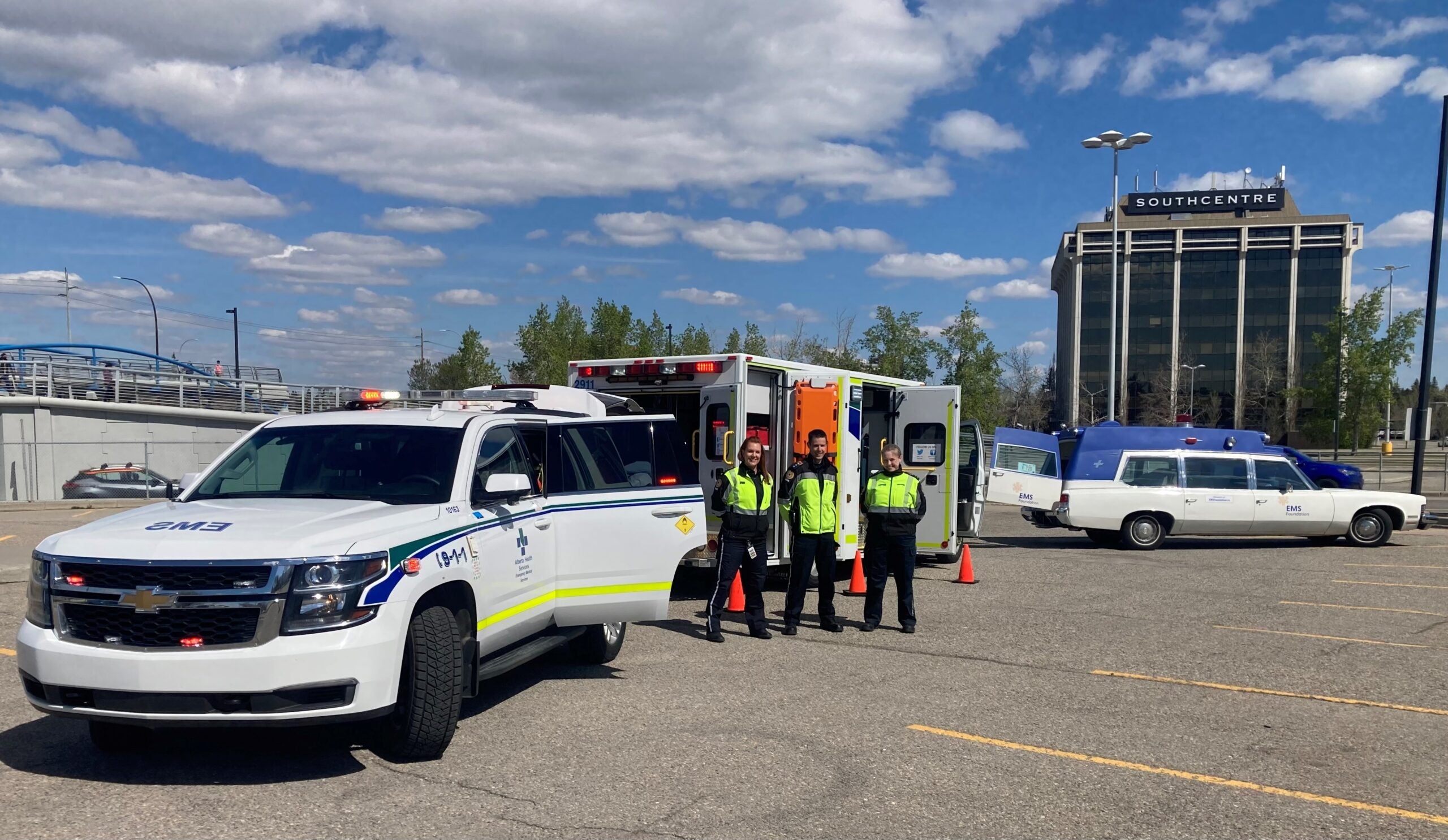 Paramedics in a parking lot with an emergency vehicle