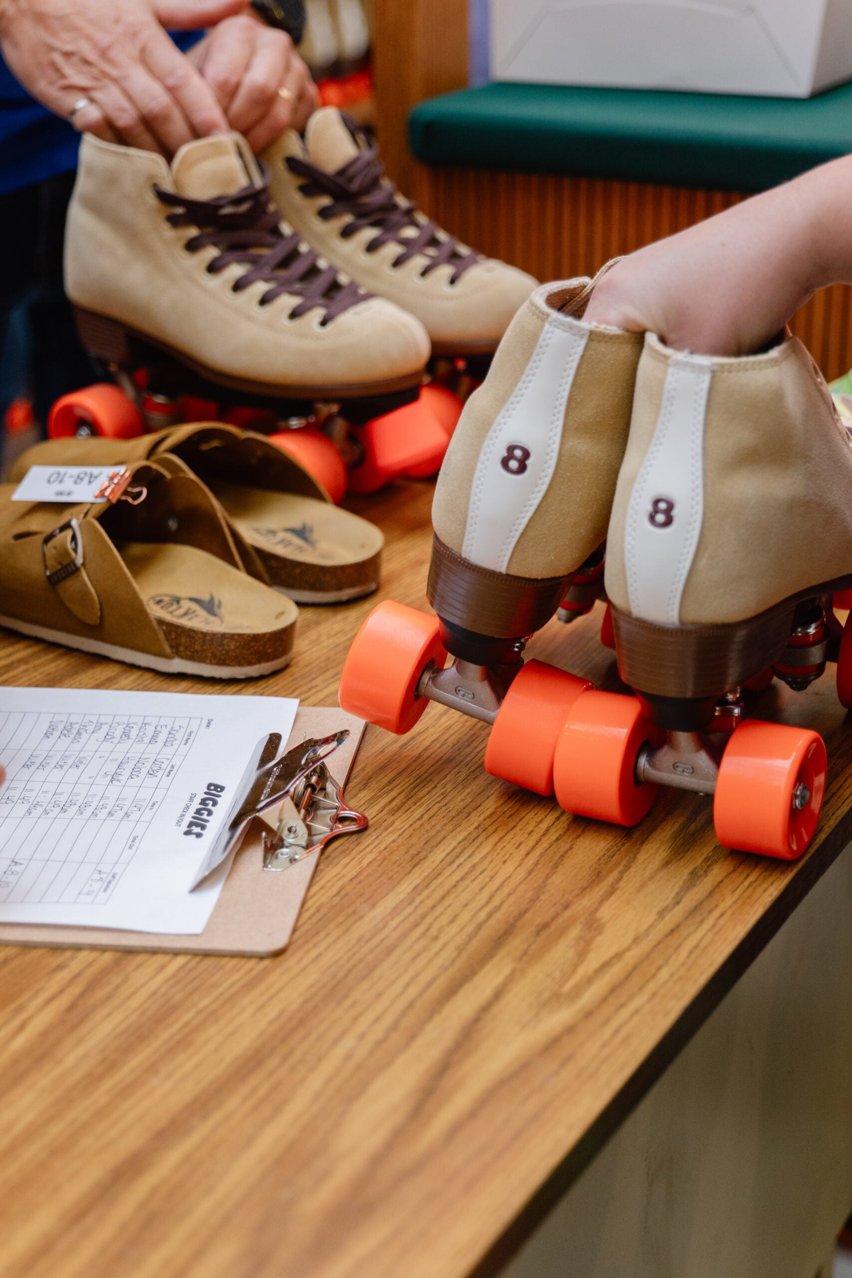 person picking up roller skates