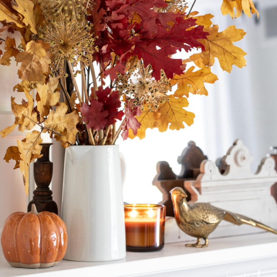 white vase with autumn leaf decor