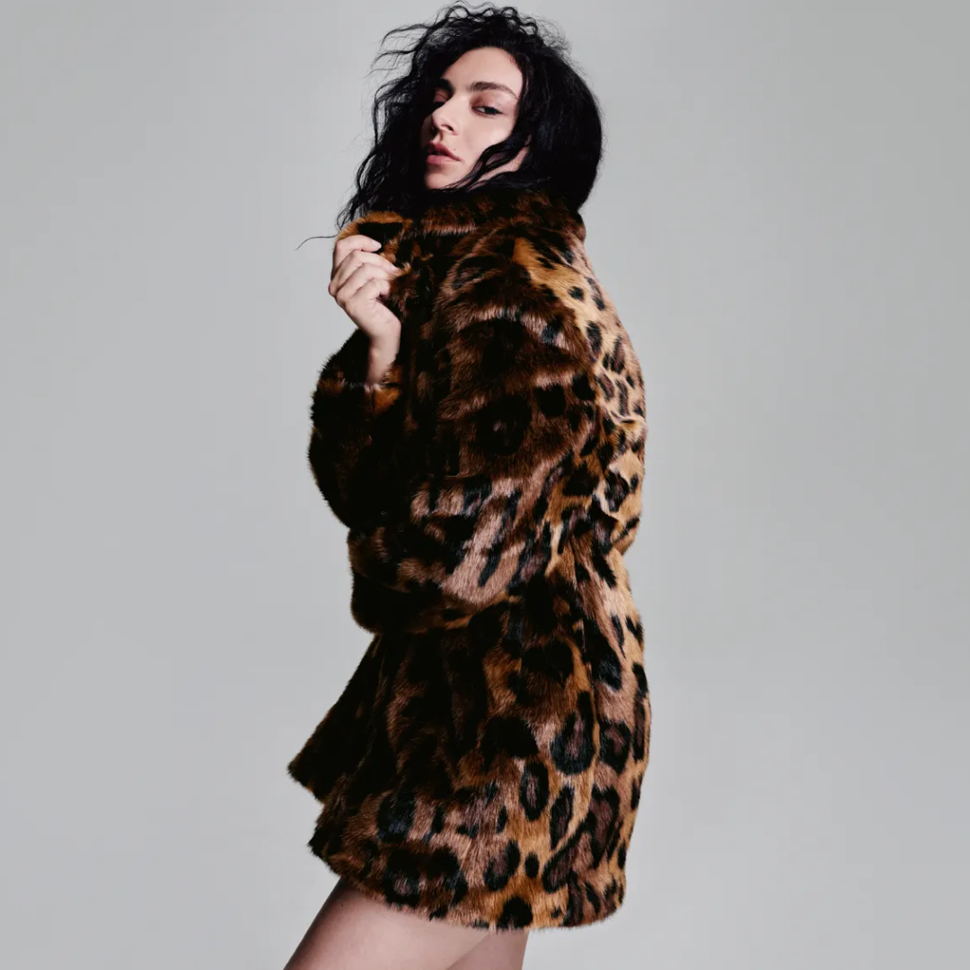 Woman wearing a leopard print fur coat from H&M, posing confidently