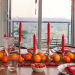 Lunar New Year table set with red, yellow and orange decor.