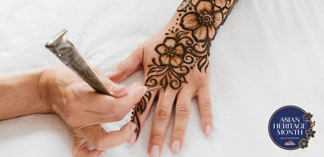 person doing henna art on hand