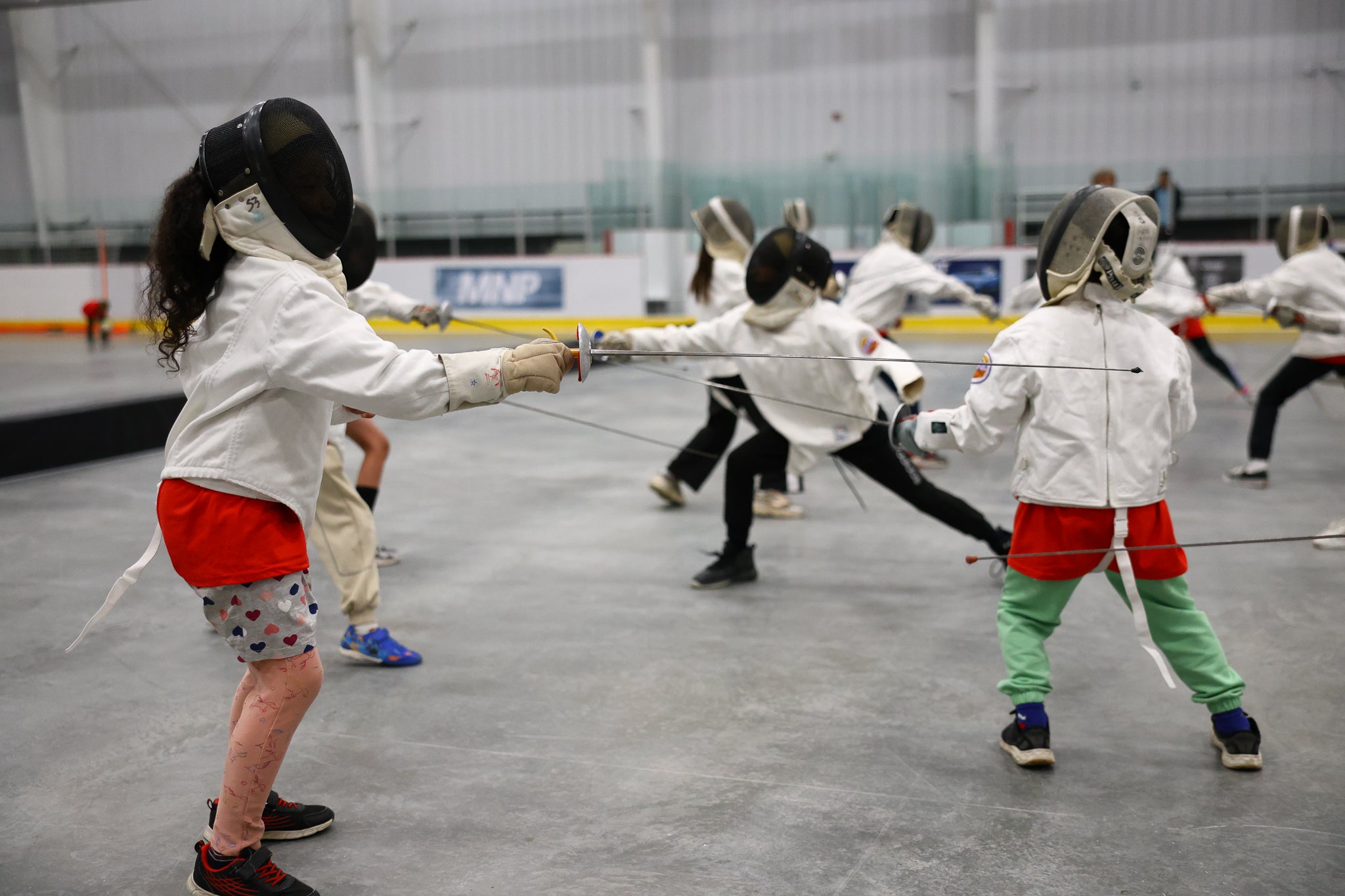 Small group of kids fencing